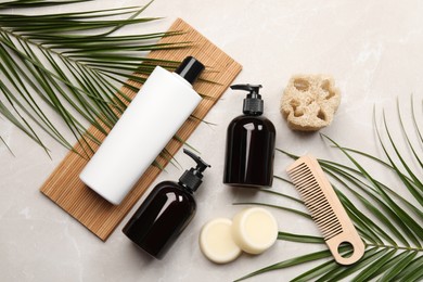 Photo of Flat lay composition with solid shampoo bars and bottles of cosmetic product on light grey table