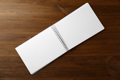 Blank paper brochure on wooden table, top view. Mockup for design
