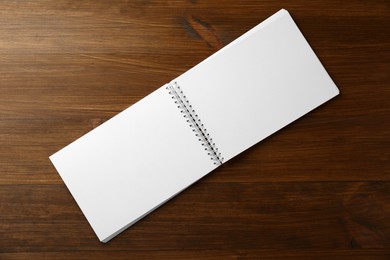 Photo of Blank paper brochure on wooden table, top view. Mockup for design