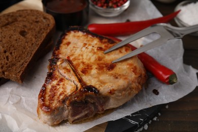 Tasty marinated meat, chili and bread on table, closeup