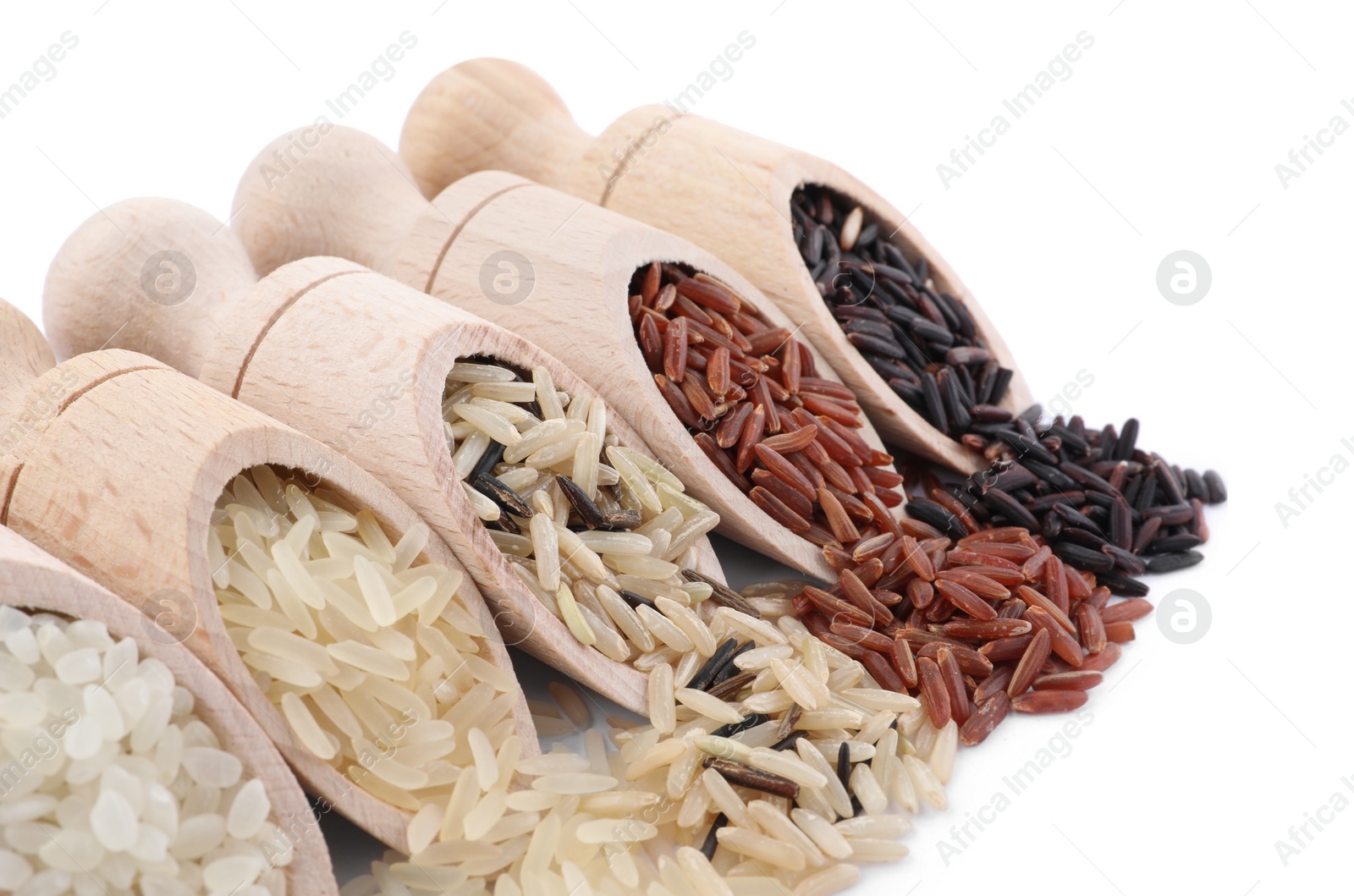 Photo of Different sorts of rice in scoops isolated on white, closeup