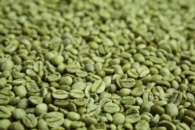 Pile of green coffee beans as background, closeup