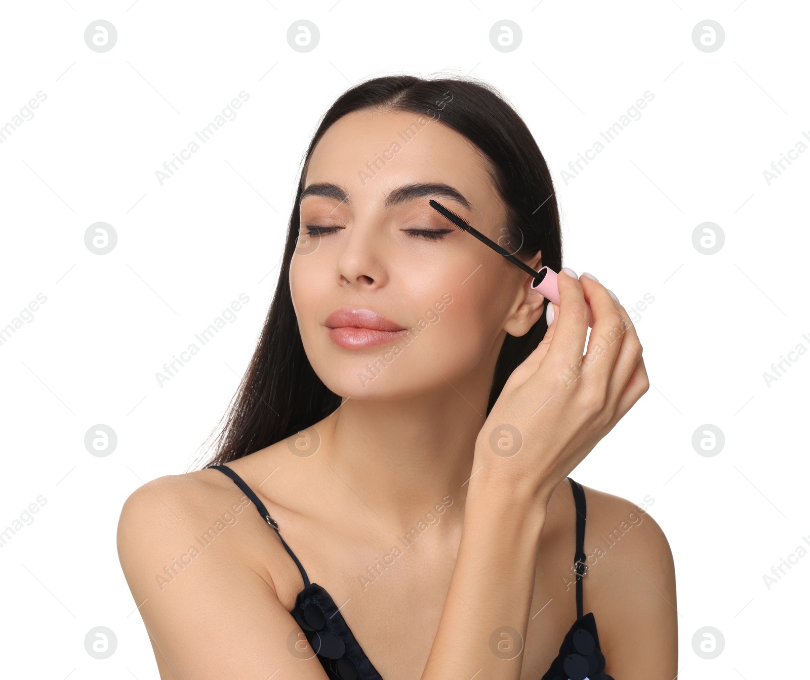 Photo of Young woman applying mascara on white background