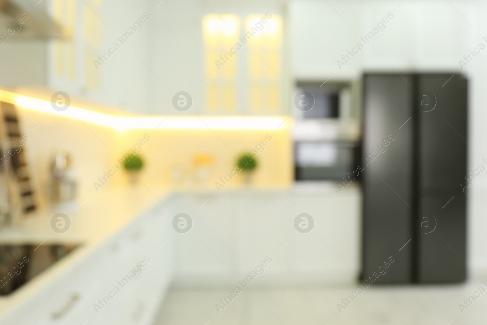 Photo of Blurred view of modern kitchen interior with stylish furniture