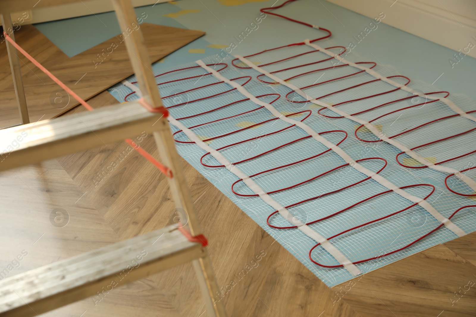 Photo of Installation of electric underfloor heating system indoors