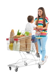 Mother and son with full shopping cart on white background