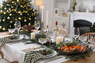 Christmas table setting with festive decor and dishware in living room