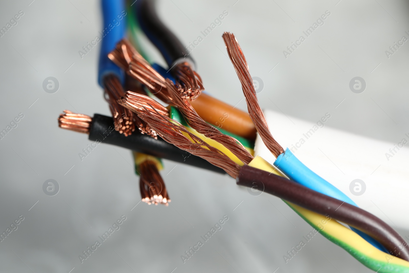 Photo of Colorful electrical wires on gray background, closeup