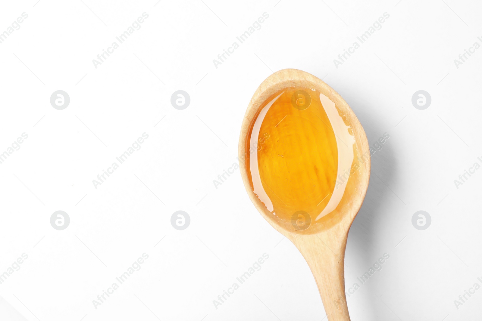 Photo of Spoon with delicious honey on white background, top view