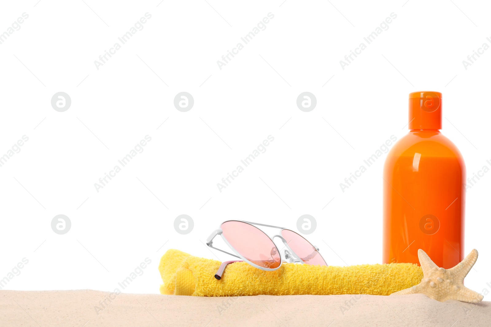 Photo of Different stylish beach accessories on sand against white background, space for text