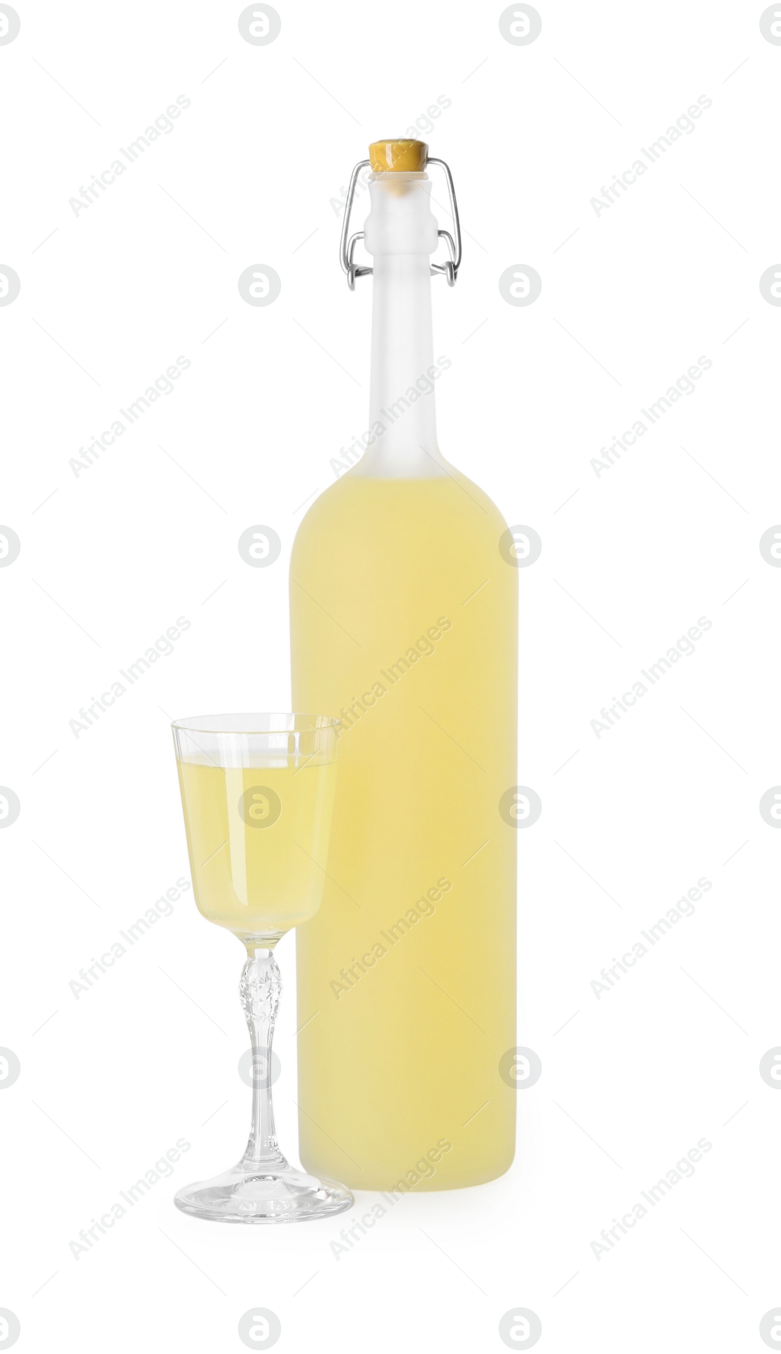 Photo of Bottle and glass with tasty limoncello liqueur isolated on white