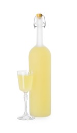 Photo of Bottle and glass with tasty limoncello liqueur isolated on white