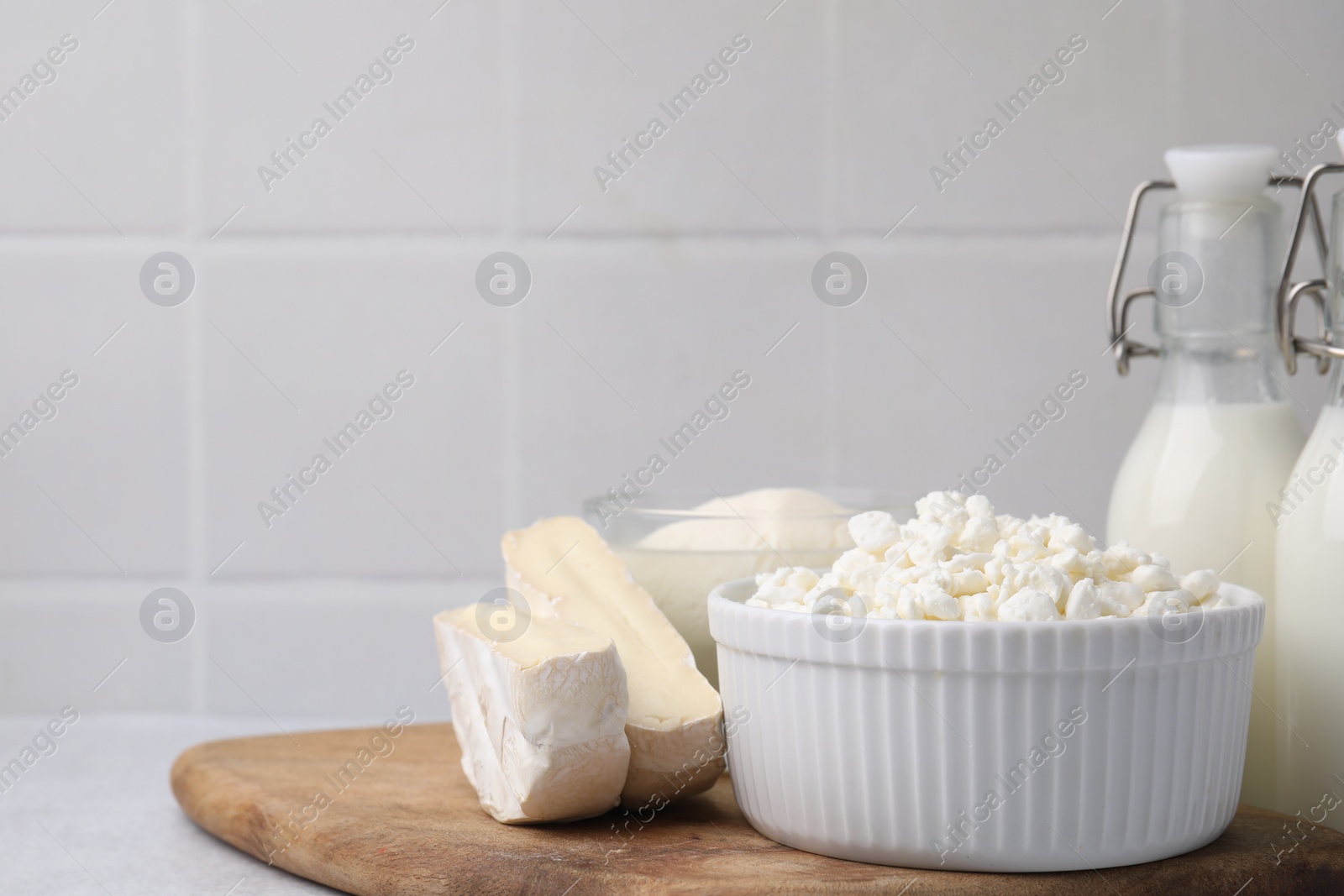 Photo of Different fresh dairy products on light table. Space for text