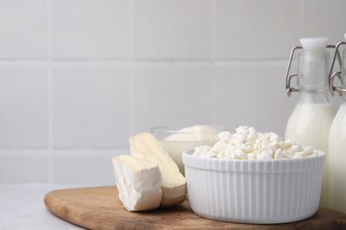 Photo of Different fresh dairy products on light table. Space for text