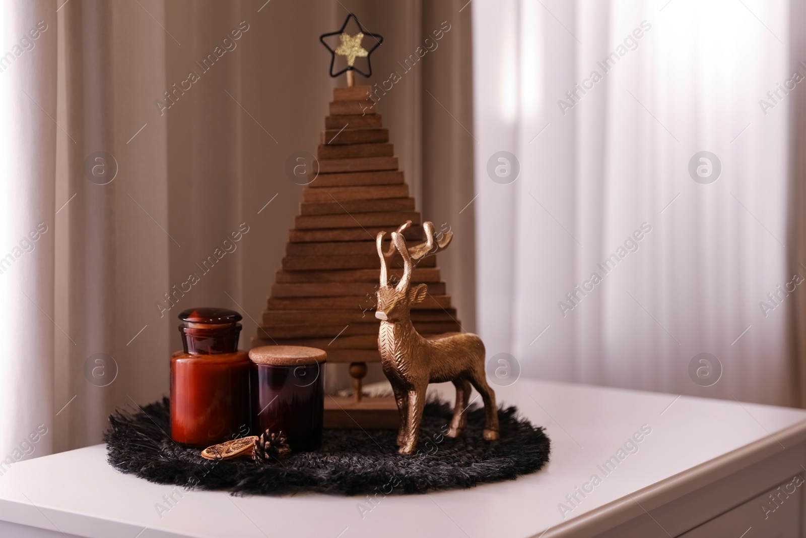 Photo of Composition with decorative Christmas tree and reindeer near window, space for text