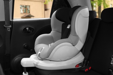 Child safety seat on backseat in car. Danger prevention