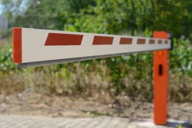 Photo of Closed boom barrier on sunny day outdoors, closeup