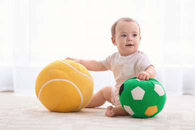 Cute baby playing with toys indoors