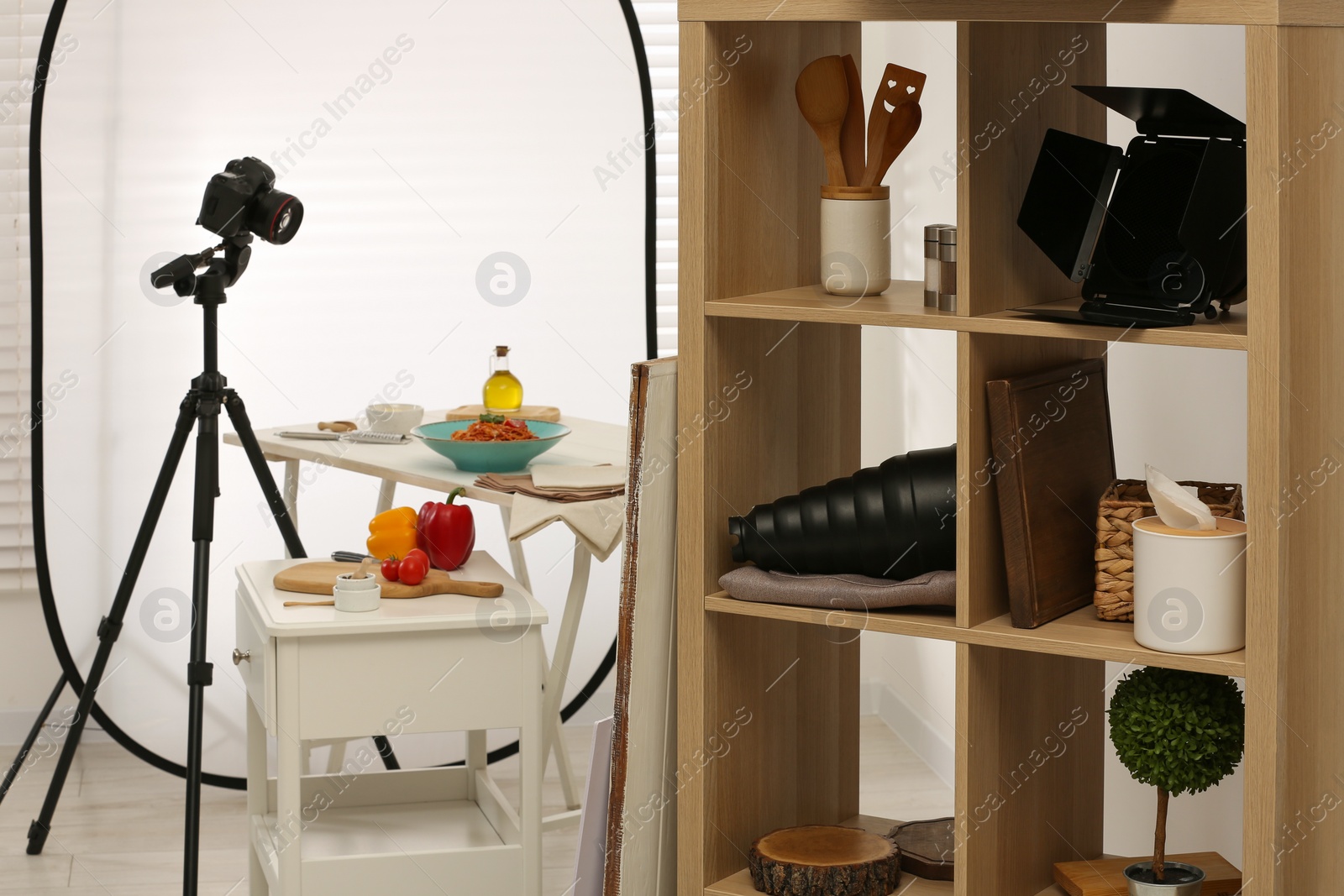 Photo of Professional equipment and composition with delicious spaghetti on white wooden table in studio. Food photography