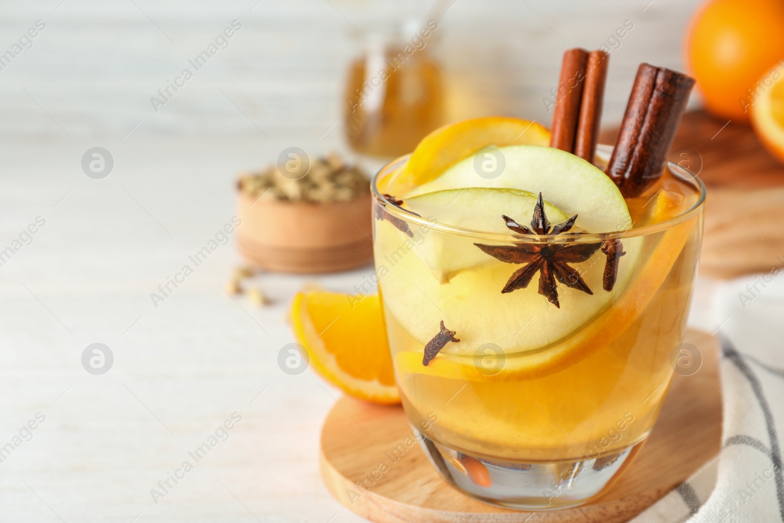 Photo of Aromatic white mulled wine on table. Space for text