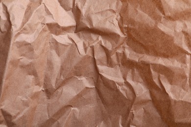 Photo of Texture of wrinkled kraft paper bag as background, closeup