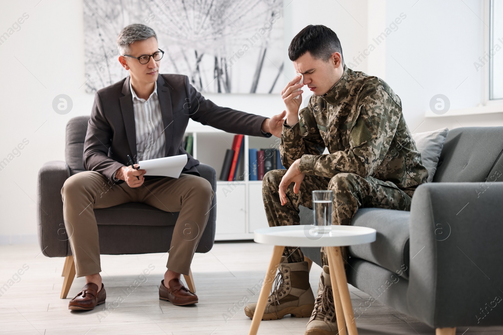 Photo of Professional psychotherapist working with military man in office