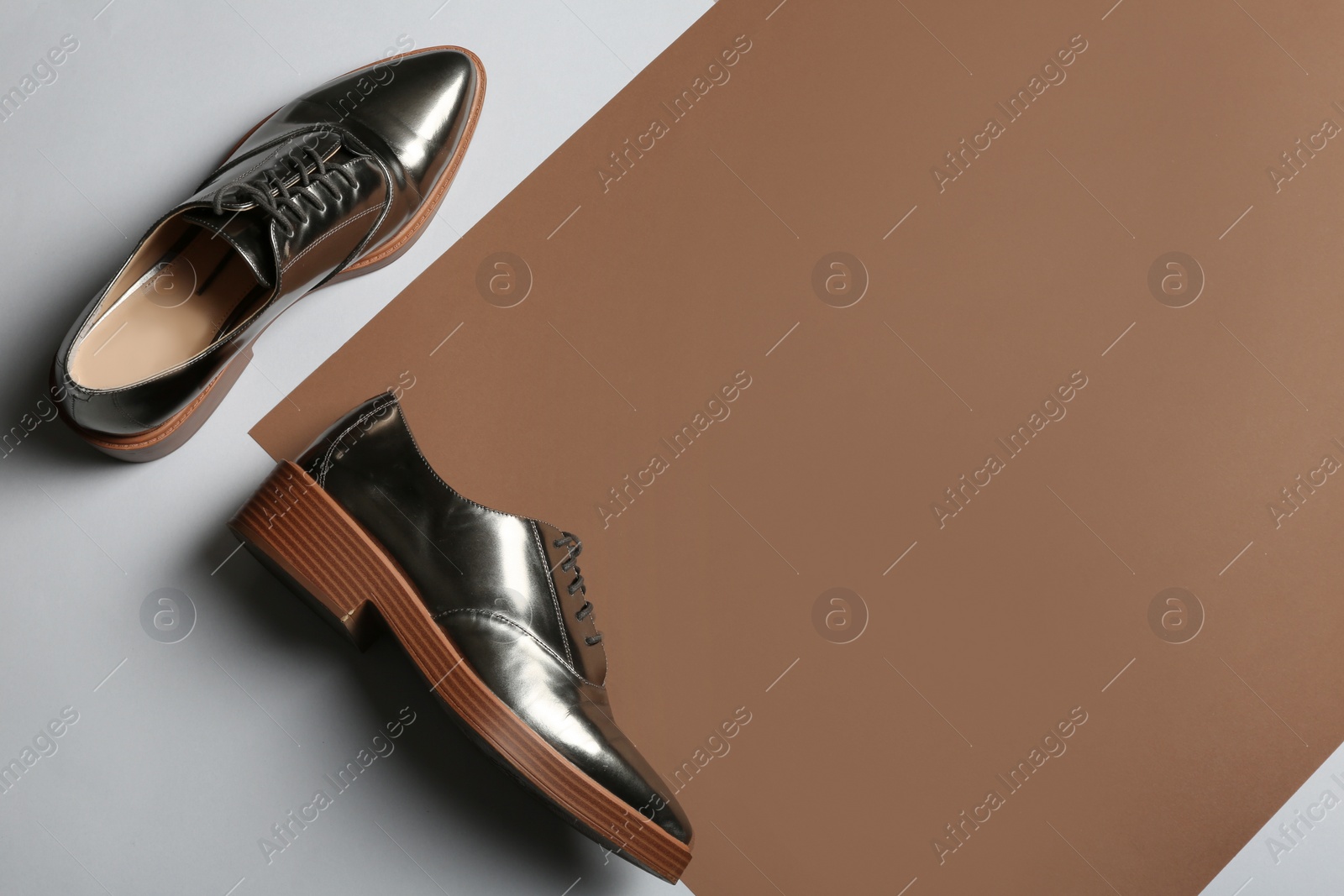 Photo of Stylish shoes on color background, top view with space for text