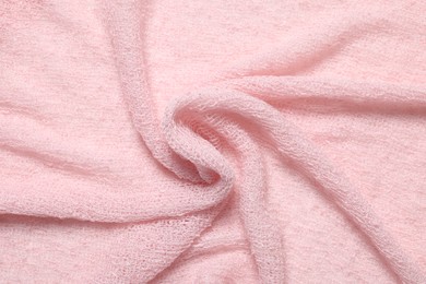 Photo of Texture of soft pink crumpled fabric as background, top view