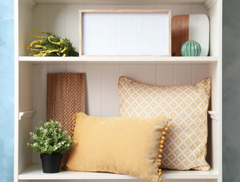 Photo of White shelving unit with different decorative stuff