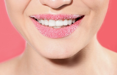 Photo of Beautiful young model with sugar lips on color background