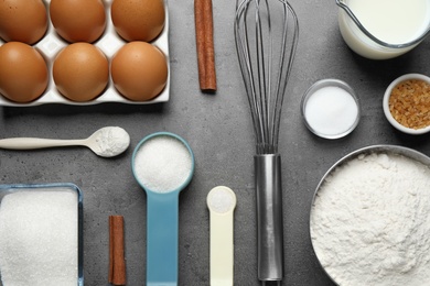 Flat lay composition with fresh ingredients for delicious homemade cake on grey table