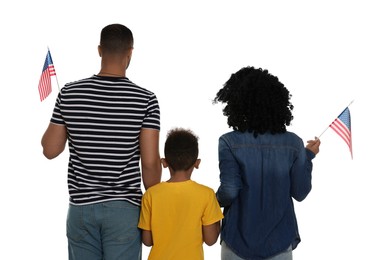 Photo of 4th of July - Independence Day of USA. Family with American flags on white background, back view