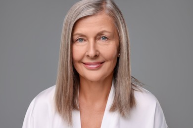 Photo of Portrait of beautiful senior woman on grey background
