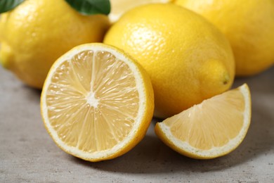 Photo of Fresh lemons on grey table, closeup. Citrus fruit