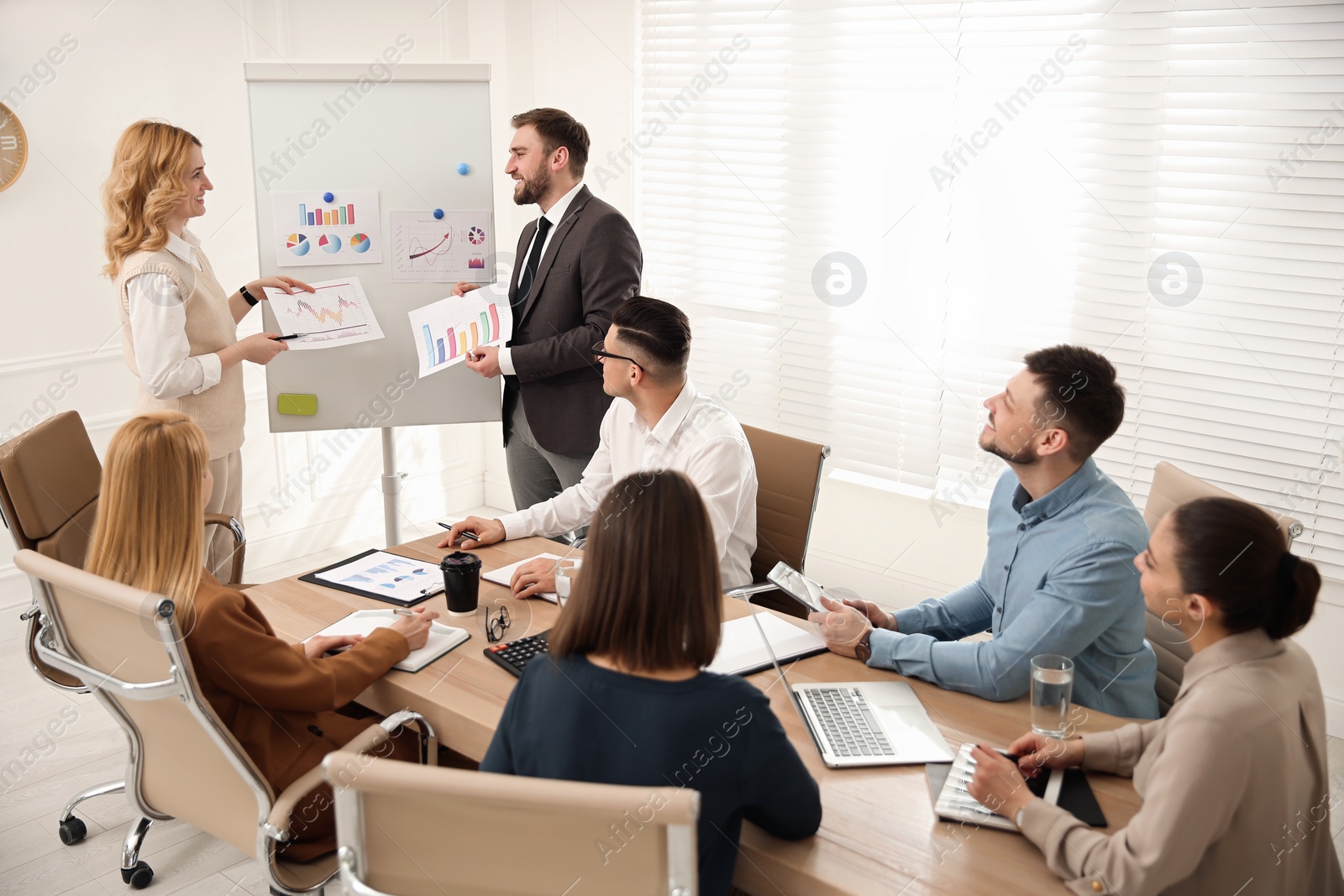 Photo of Businesspeople having meeting in office. Management consulting