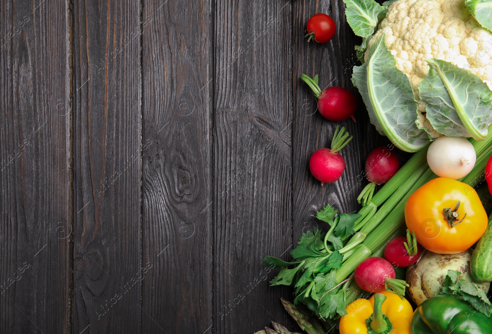 Photo of Flat lay composition with assortment of fresh vegetables on wooden table. Space for text