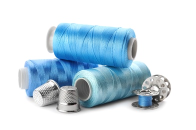 Photo of Color threads and sewing accessories on white background