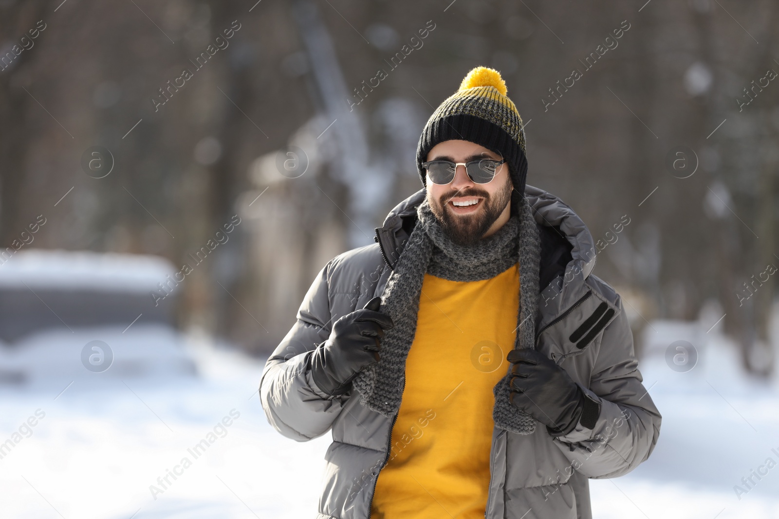 Photo of Portrait of handsome young man with sunglasses on winter day outdoors