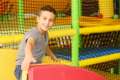 Cute little child playing at indoor amusement park