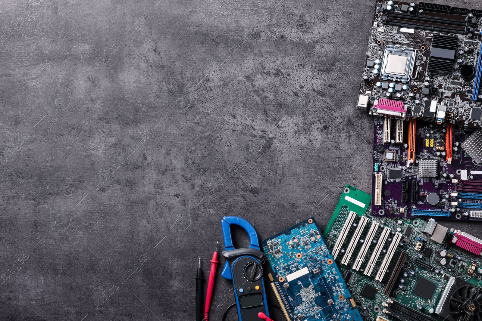 Photo of Computer motherboards on grey table, flat lay with space for text. Electronic device