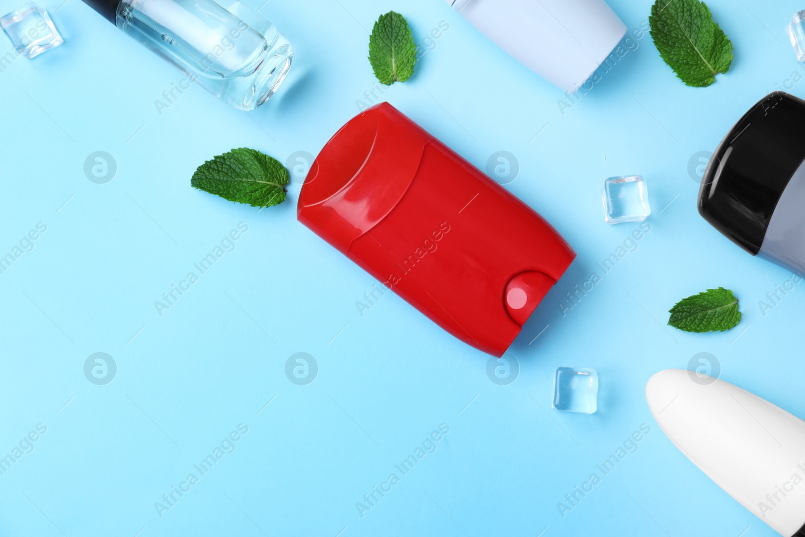 Photo of Flat lay composition with different male deodorants on light blue background, space for text