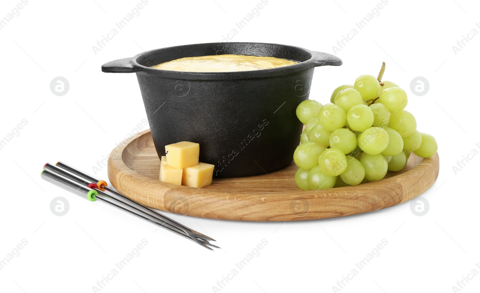 Photo of Fondue with tasty melted cheese, forks and grapes isolated on white