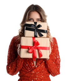 Beautiful young woman with Christmas presents on white background
