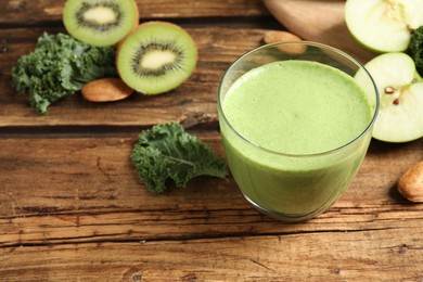 Photo of Tasty fresh kale smoothie on wooden table, closeup