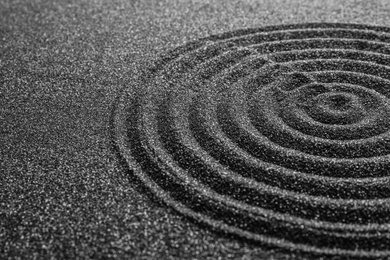 Photo of Black sand with beautiful pattern, closeup. Zen concept