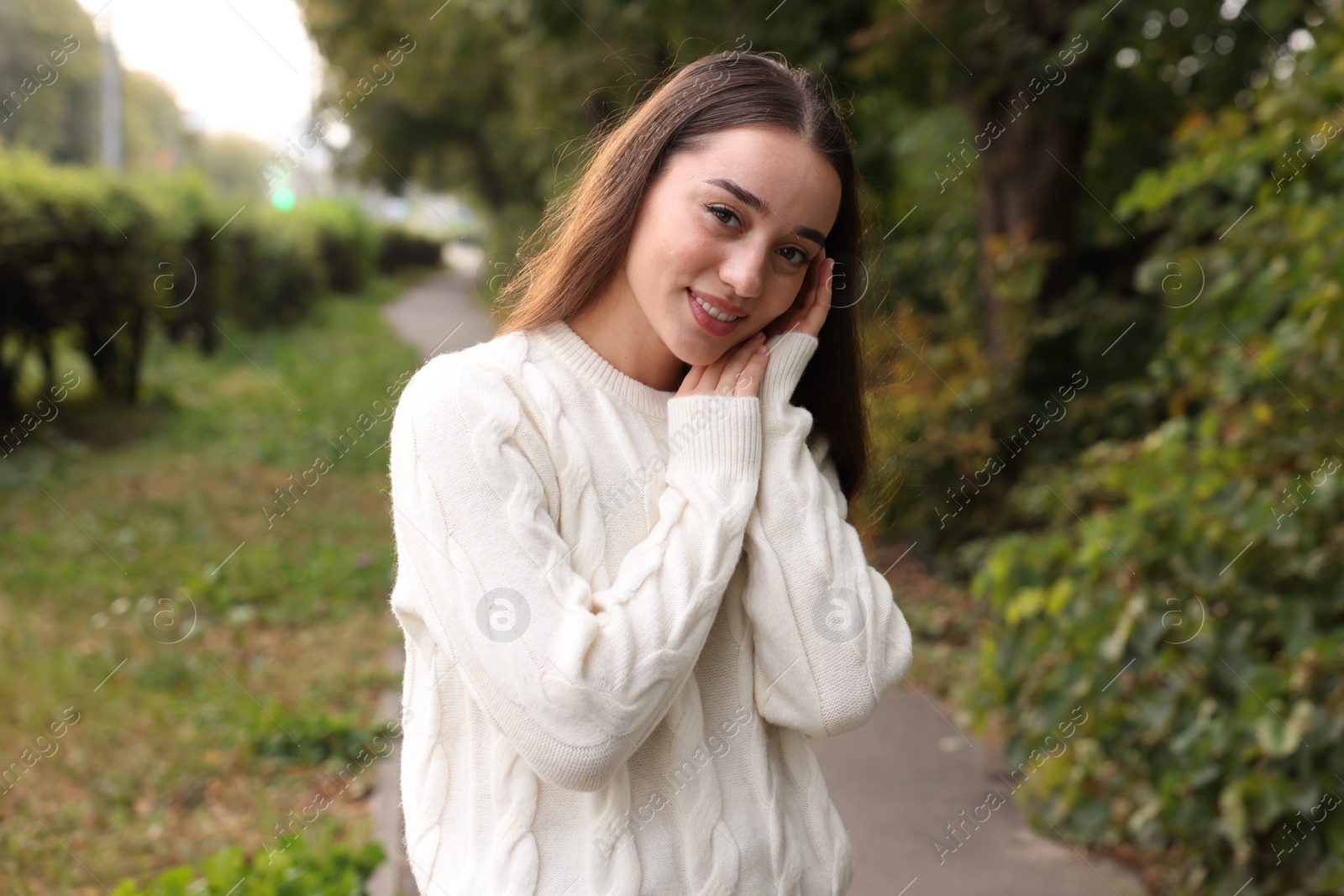 Photo of Beautiful young woman in stylish warm sweater outdoors