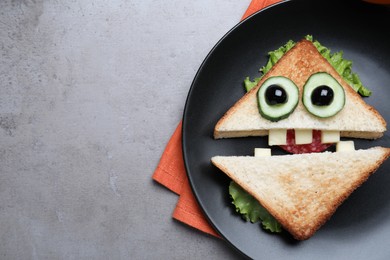 Photo of Cute monster sandwich served on grey table, top view with space for text. Halloween party food