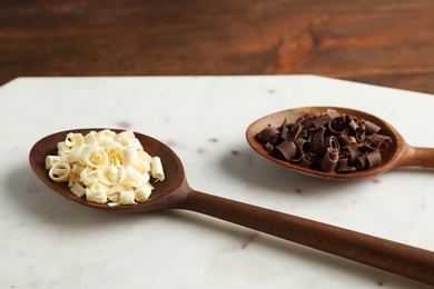 Spoons with different chocolate curls on board