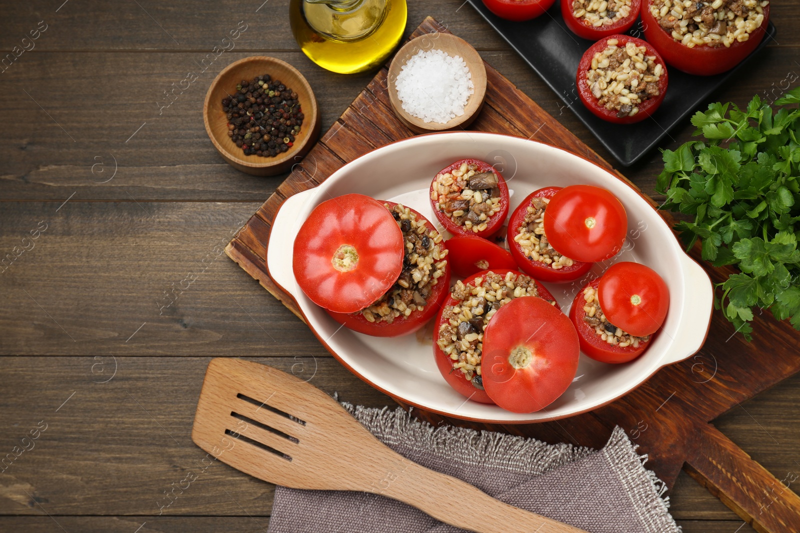 Photo of Delicious stuffed tomatoes with minced beef, bulgur and mushrooms on wooden table, flat lay. Space for text