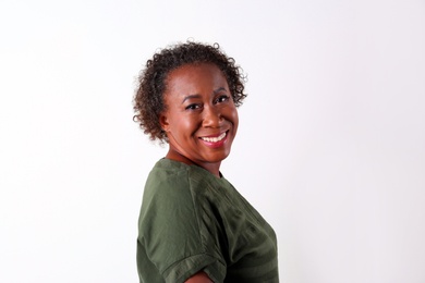 Photo of Portrait of happy African-American woman on white background